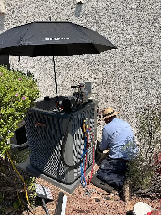 HVAC technician performing outdoor AC maintenance in Anderson Creek