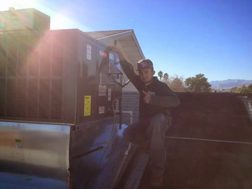 HVAC technician performing HVAC Inspection on a rooftop unit in Anderson Creek